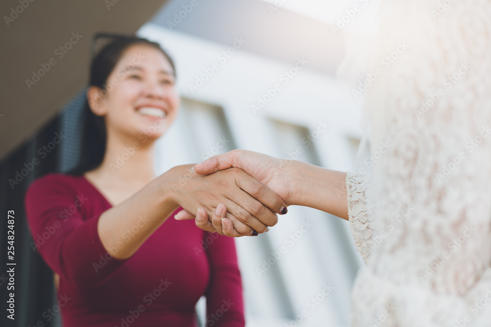 Negotiating business,Image of businesswomen Handshaking,happy with work,the woman she is enjoying with her workmate,Handshake Gesturing People Connection Deal Concept Negotiating business,Image of businesswomen Handshaking,happy with work,the woman she is enjoying with her workmate,Handshake Gesturing People Connection Deal Concept