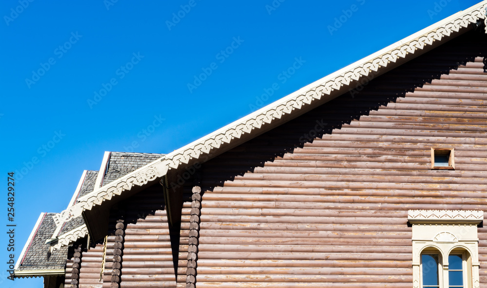 Part of the roof of the house against the blue sky