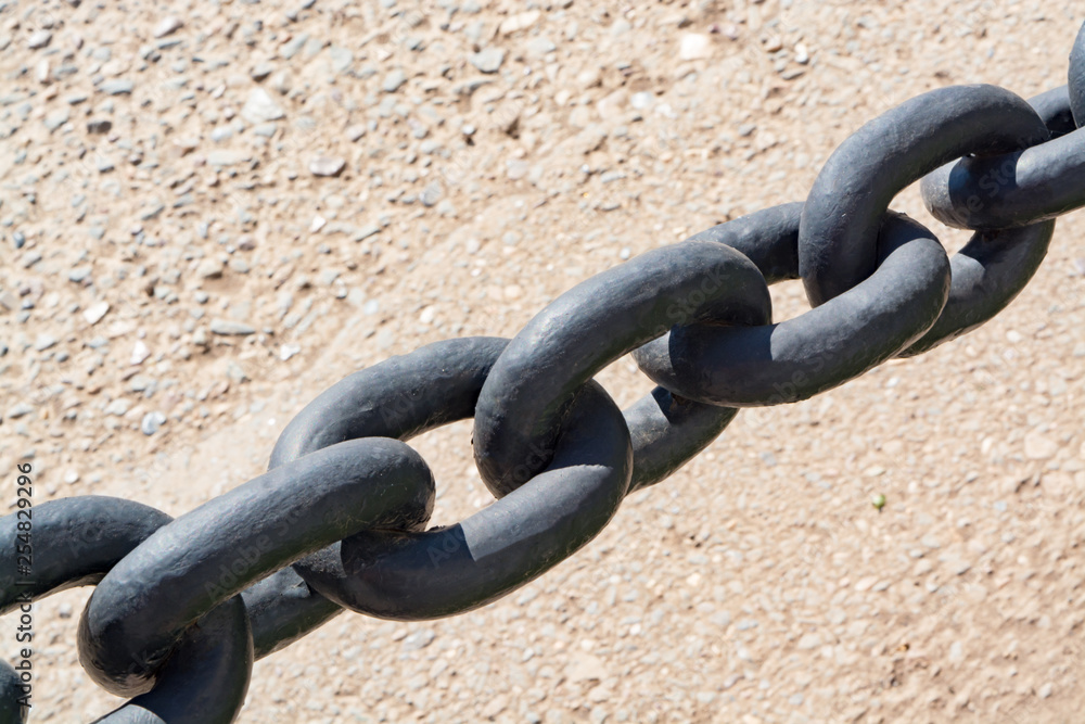 Black chain close up on asphalt background Black chain close up on asphalt background