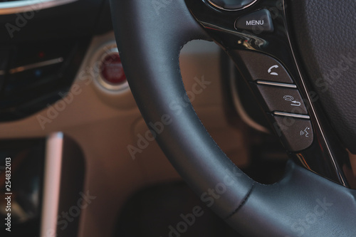 mobile call hands-free control button on steering wheel of modern vehicle car © sutichak