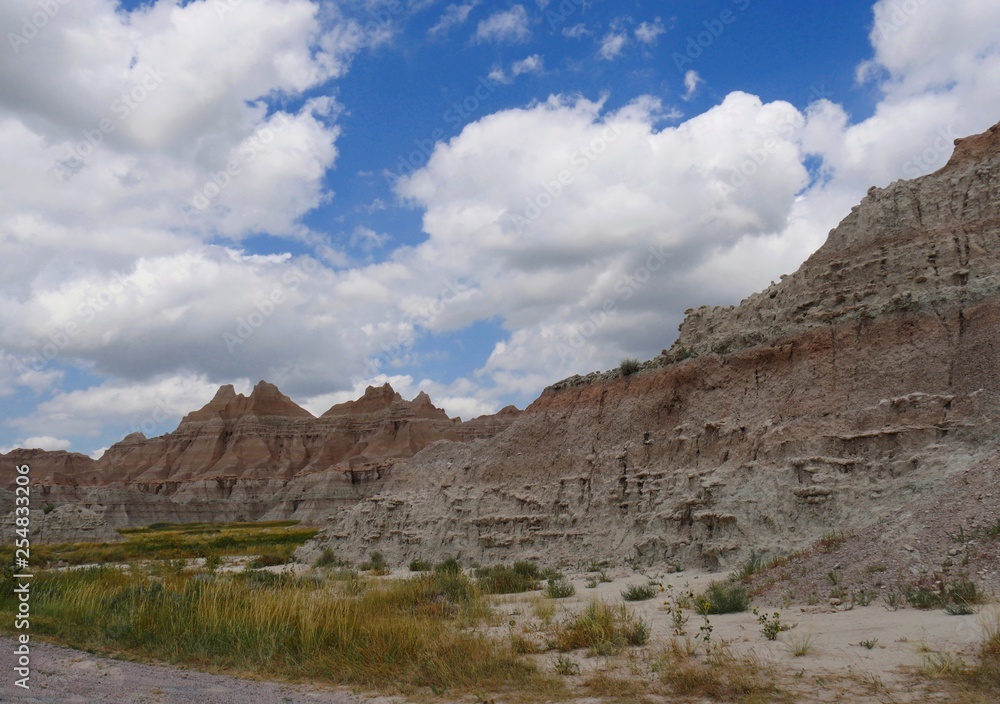 Amazing buttes and rock formations with beautiful clouds at the Badlands National Park in South Dakota.