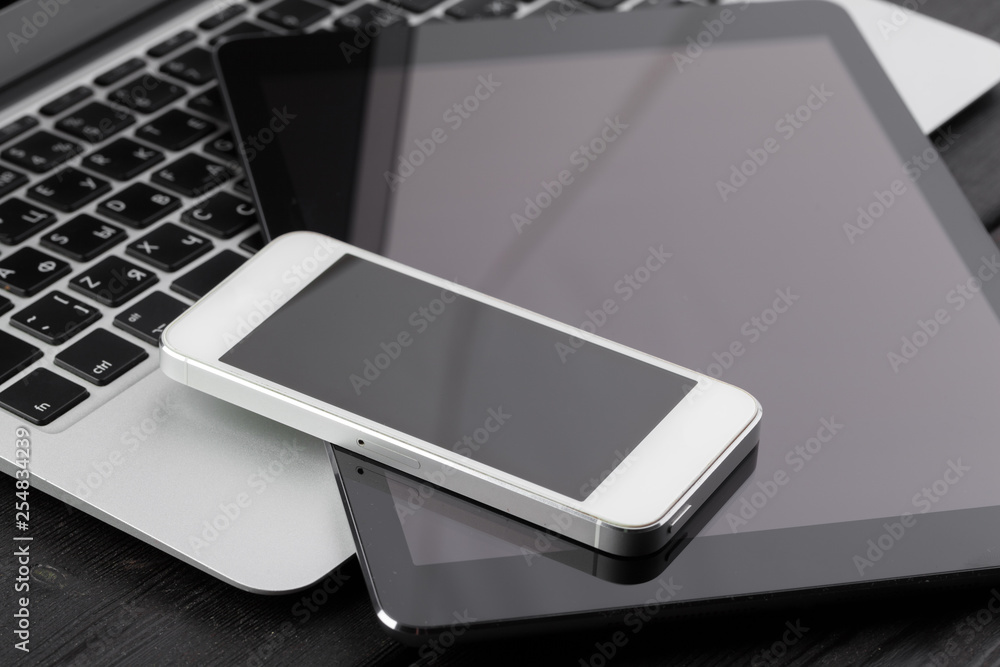 Open laptop with digital tablet and smartphone close up Open laptop with digital tablet and smartphone close up