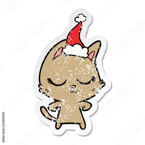 calm distressed sticker cartoon of a cat wearing santa hat