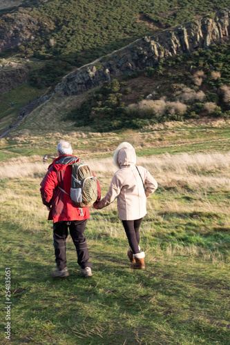 Elderly couple walking in the mountains