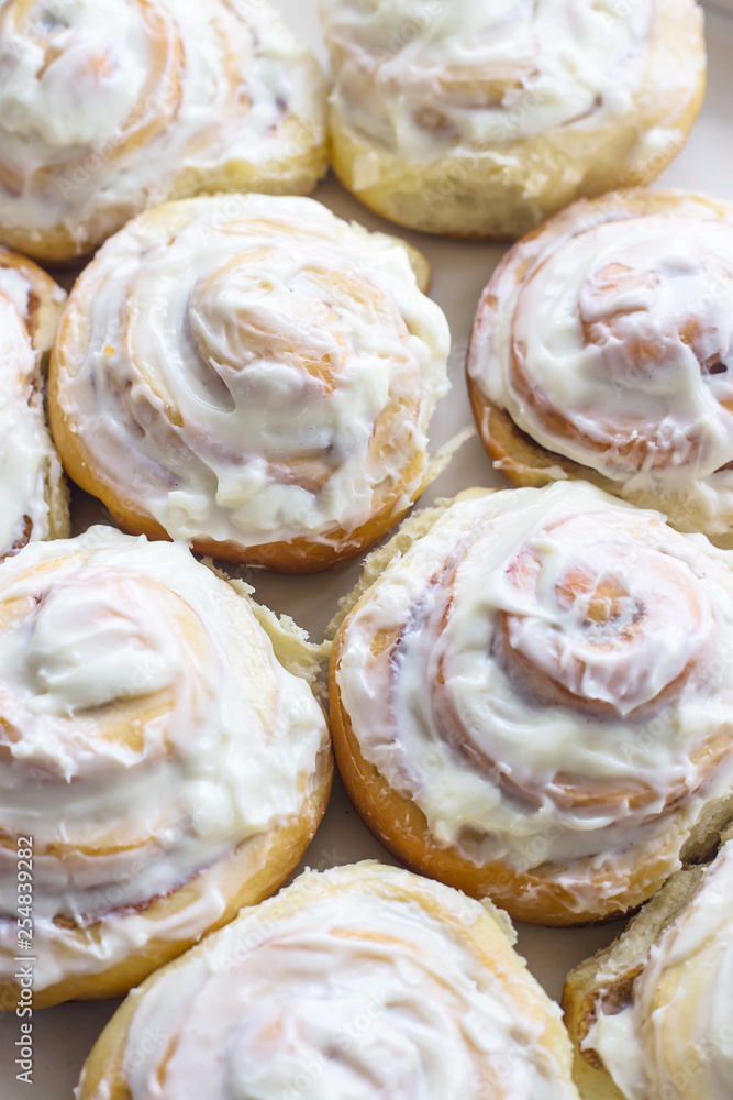 Swedish cinnamon rolls with white cream on top Swedish cinnamon rolls with white cream on top