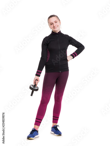 Sports and healthcare concept. Smiling teen girl in sportswear working out in studio