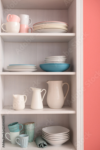 Set of clean dishes on shelves