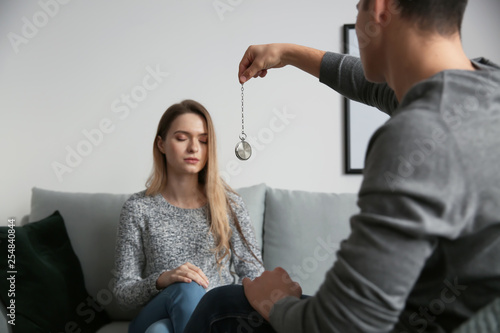 Young woman during hypnosis session in psychologist's office photo