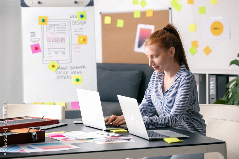Female IT designer working in office Female IT designer working in office