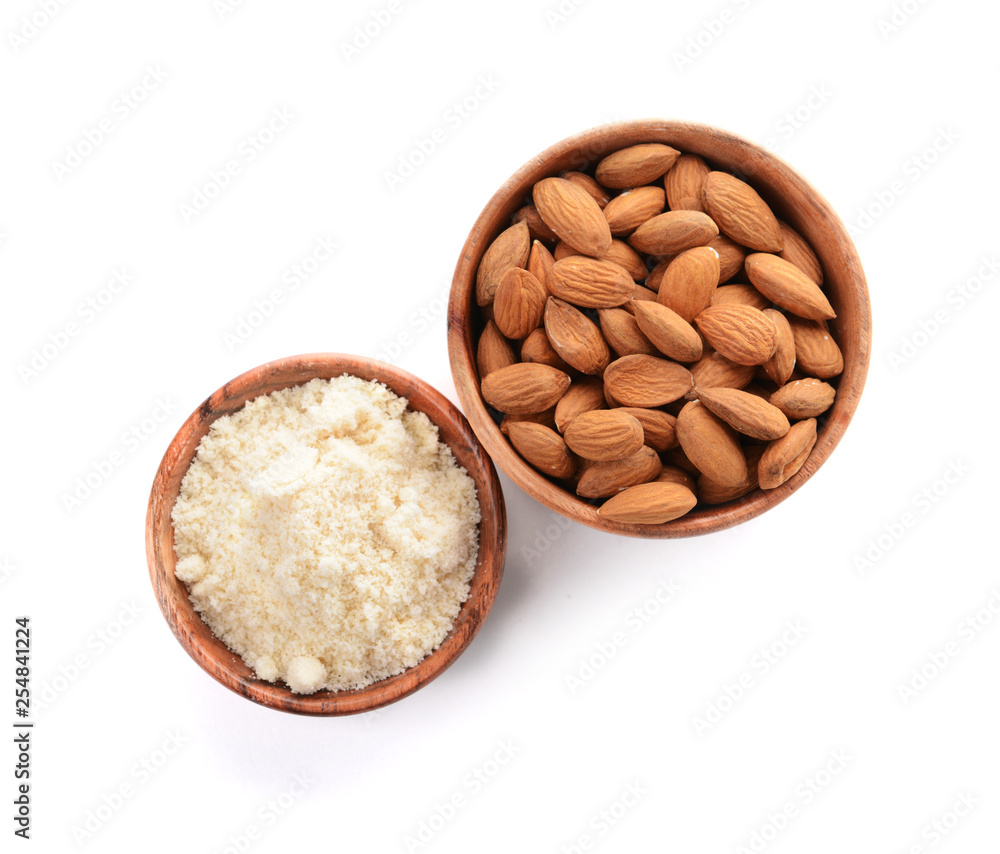 Bowls with almonds and flour on white background Bowls with almonds and flour on white background