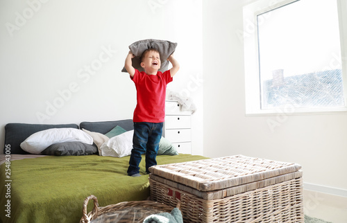 Happy little boy playing wi...