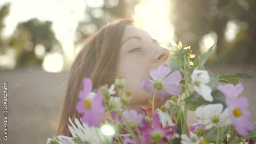 Portrait of beautiful young woman smiling and holding bouquet of wild flowers. Portrait of beautiful young woman smiling and holding bouquet of wild flowers.