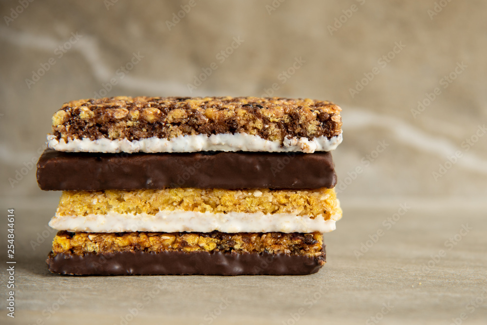 Various muesli bars on marble stone background Various muesli bars on marble stone background