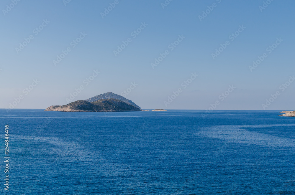 Beautiful landscape with calm blue water and rocky island, antalya, turkey Beautiful landscape with calm blue water and rocky island, antalya, turkey