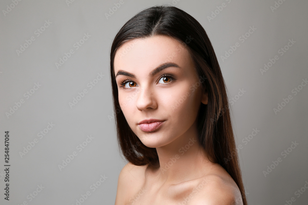 Portrait of beautiful woman with healthy skin on grey background Portrait of beautiful woman with healthy skin on grey background