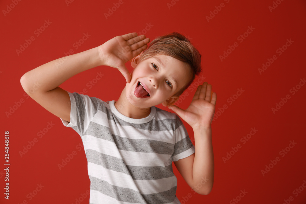 Funny grimacing little boy on color background Funny grimacing little boy on color background