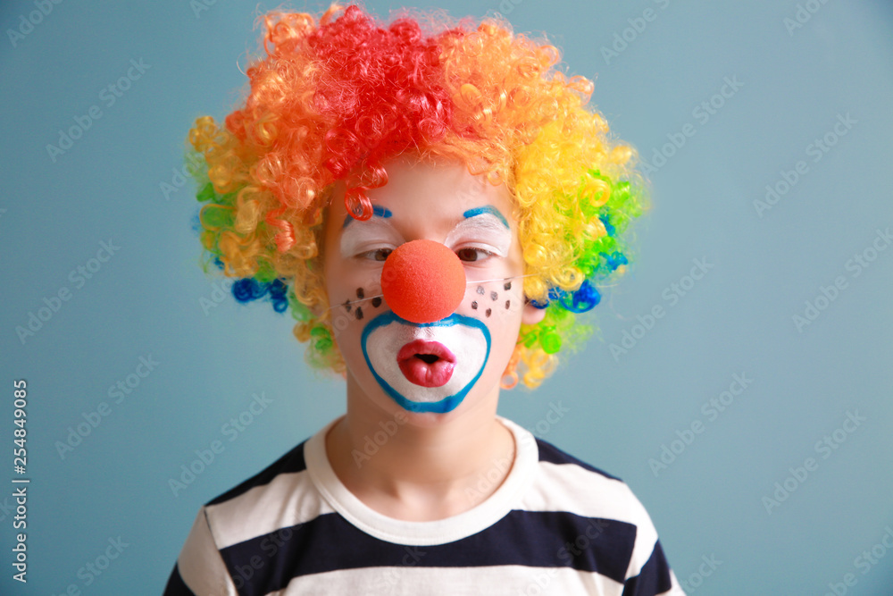 Cute little boy with clown makeup on color background. April fools' day celebration Cute little boy with clown makeup on color background. April fools' day celebration