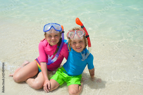 Happy children wearing snorkeling gear on the beach