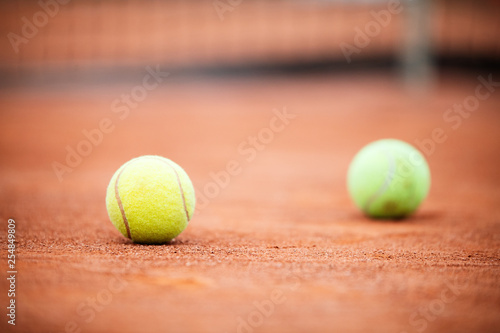 Close up of tennis ball on clay court./Tennis ball © NDABCREATIVITY