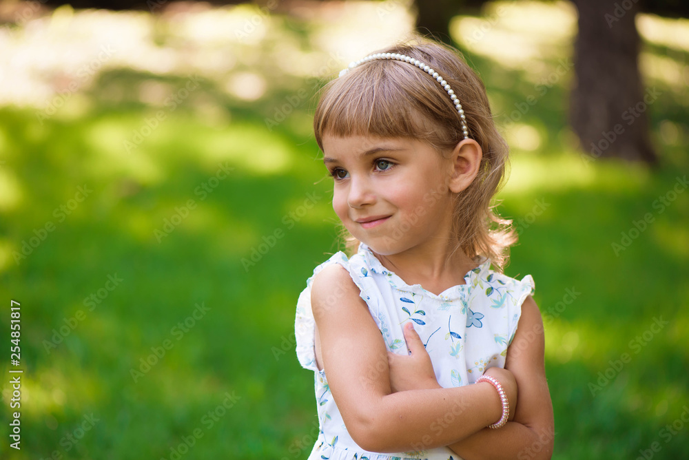 Beautiful little young girl outdoorin a park. Beautiful little young girl outdoorin a park.