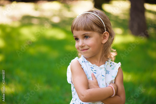 Beautiful little young girl outdoorin a park.