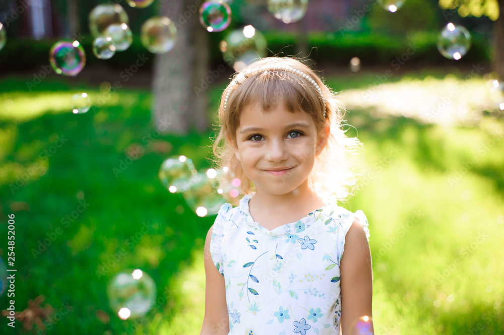 Sweet, happy, smiling five year old girl laying on a grass Sweet, happy, smiling five year old girl laying on a grass