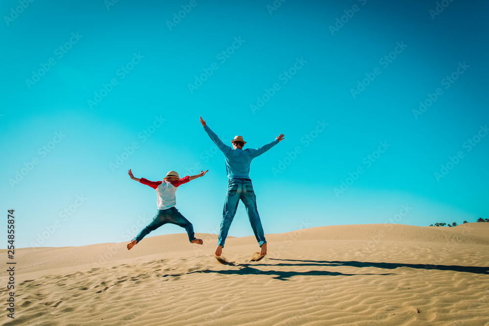 happy father and son having fun in sand dunes happy father and son having fun in sand dunes