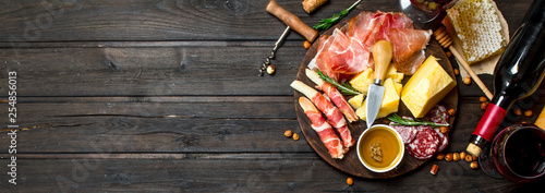 Antipasto background.Various meat and cheese snacks with red wine.