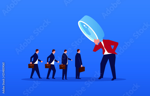 A group of businessmen stand in a row to accept the foreman’s review