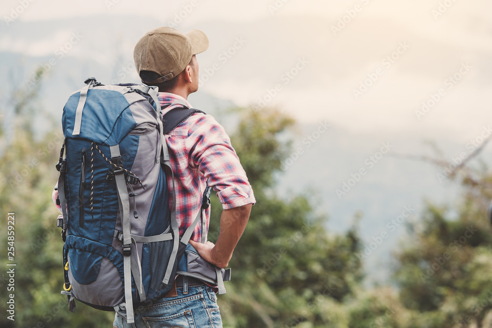 Hiking man traveling with backpack in mountains Hiking man traveling with backpack in mountains