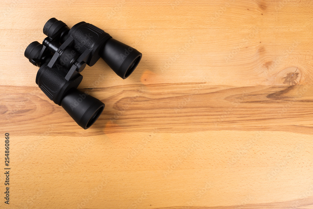 Binoculars on the wooden table Binoculars on the wooden table