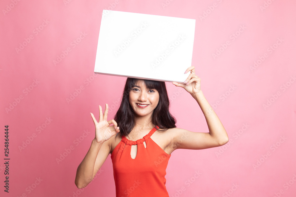 Young Asian woman show OK with  white blank sign.