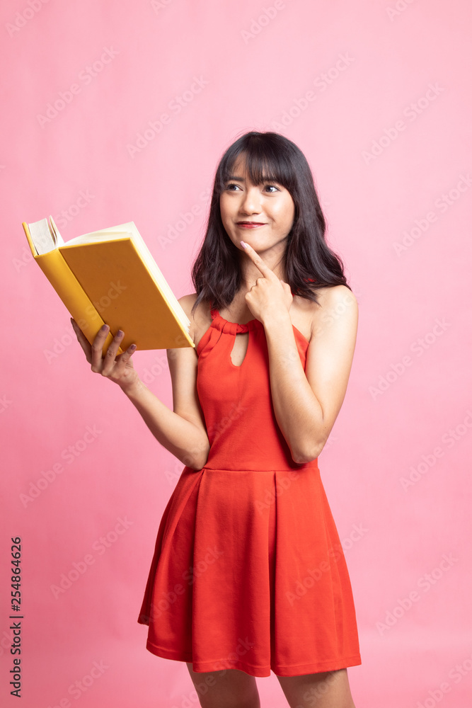 Young Asian woman with a book is thinking.