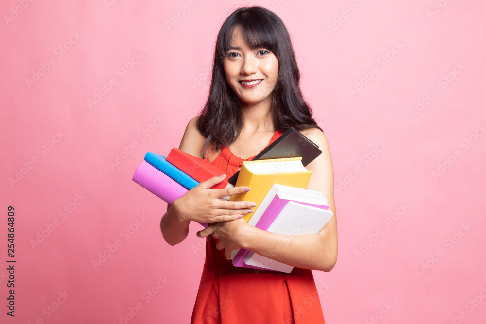 Young Asian woman studying with may books. Young Asian woman studying with may books.