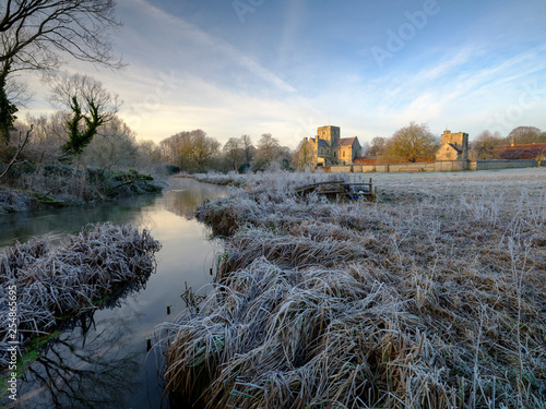 Frosty winter sunrise with a hoarfrost view of St Cross Hospital, Winchester, Hampshire, UK photo