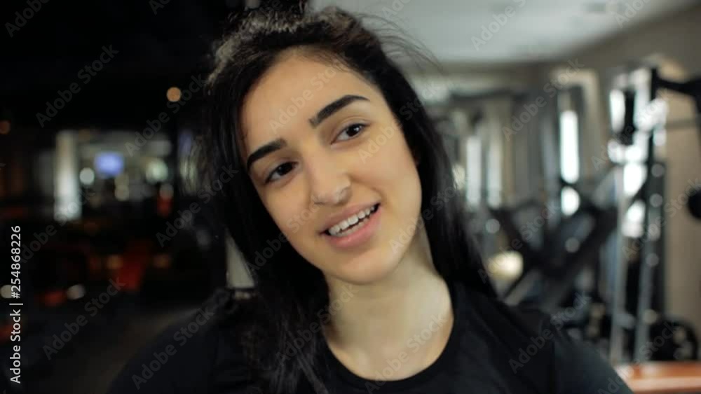 cute caucasian brunette girl in black sports top smiling.good attitude cute caucasian brunette girl in black sports top smiling.good attitude