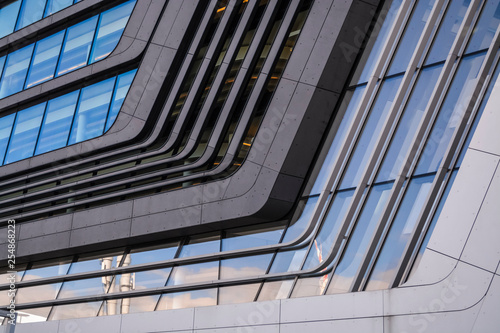 Modern and unusual architecture from metal and glass. Non-standard forms and decisions. Lines and geometry of the big building. 