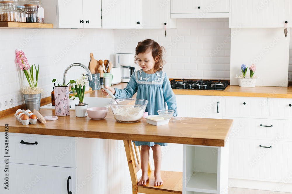 Little girl preparing easter cookies at the kitchen. Little girl preparing easter cookies at the kitchen.