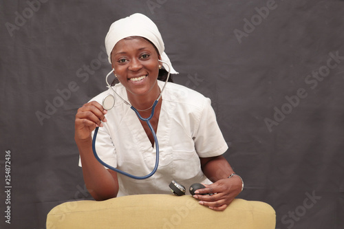black nurse woman dressed in white coat with beautiful smile