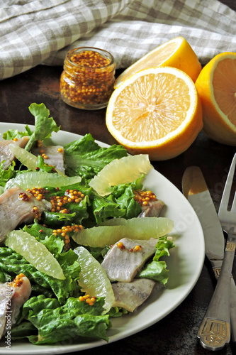 Fitness salad with lemon, lettuce and herring fillet. Fresh salad for weight loss. Ketogenic diet.