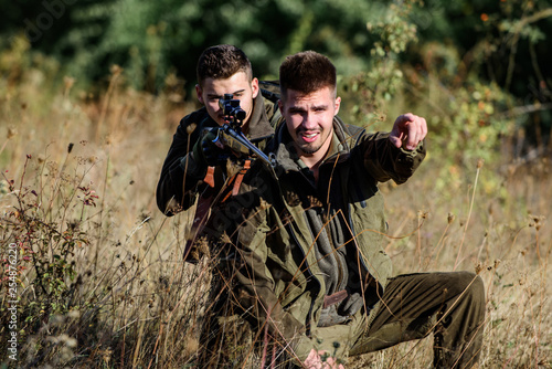 Activity for real men concept. Hunters with rifles in nature environment. Hunters gamekeepers looking for animal or bird. Hunting with friends. Hunters friends enjoy leisure. Teamwork and support