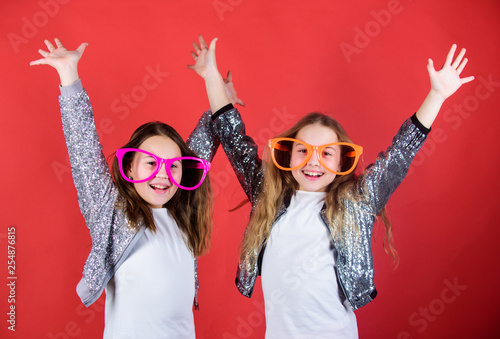 Joyful and cheerful. Sisterhood concept. Friendly relations siblings. Sincere cheerful kids share happiness and love. Girls funny big eyeglasses cheerful smile. Birthday party. Happy childhood