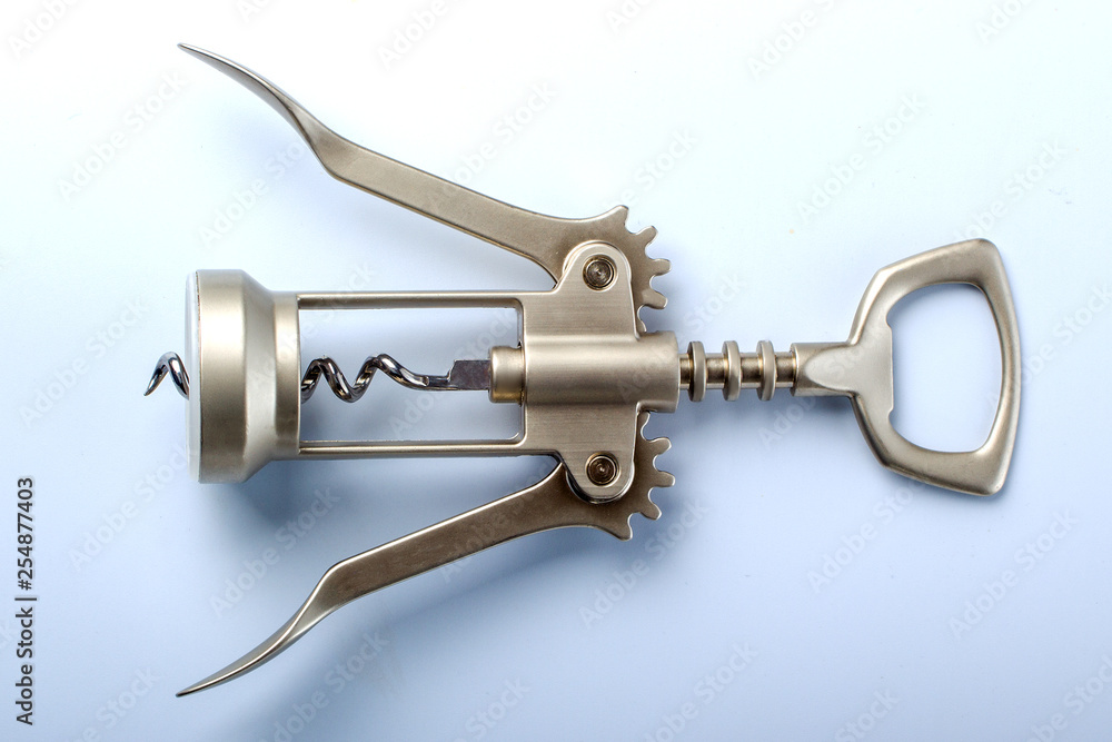 metal corkscrew on light blue background metal corkscrew on light blue background