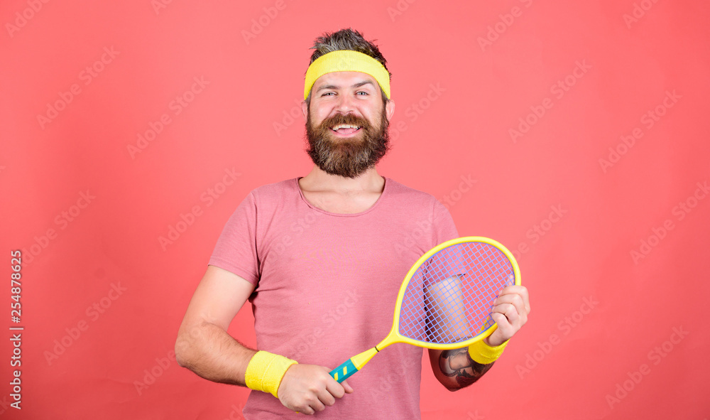 Tennis active leisure. Tennis player vintage fashion. Tennis sport and entertainment. Athlete hipster tennis racket in hand red background. Man bearded hipster wear sport outfit. Having fun foto de Stock