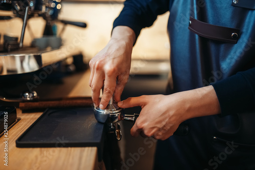 Barista hand pours beverage from coffee machine