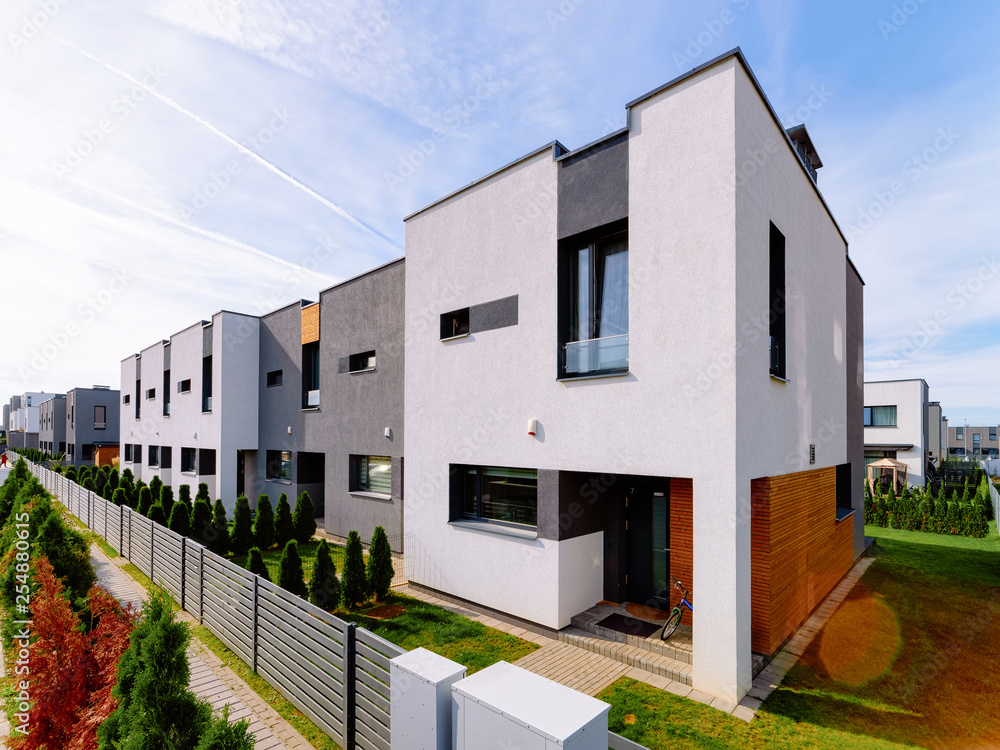 Apartment residential house building complex with gate sun light