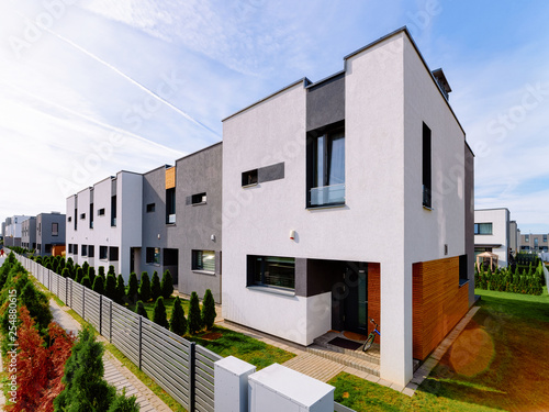 Apartment residential house building complex with gate sun light photo