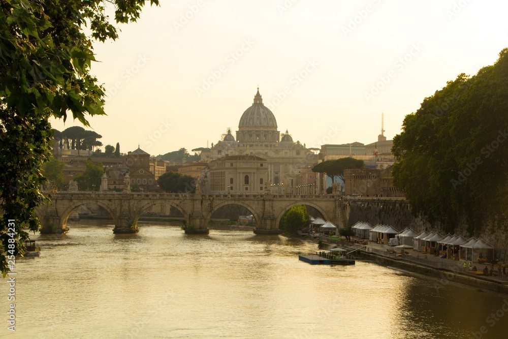 Beautiful view of St. Peter's Basilica in the Vatican from the Tiber River in Rome. St. Peter's Basilica and Aelian Bridge across Tiber River in Rome, Italy.