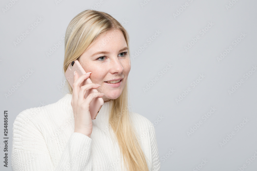 young blonde woman is talking on the mobile phone young blonde woman is talking on the mobile phone