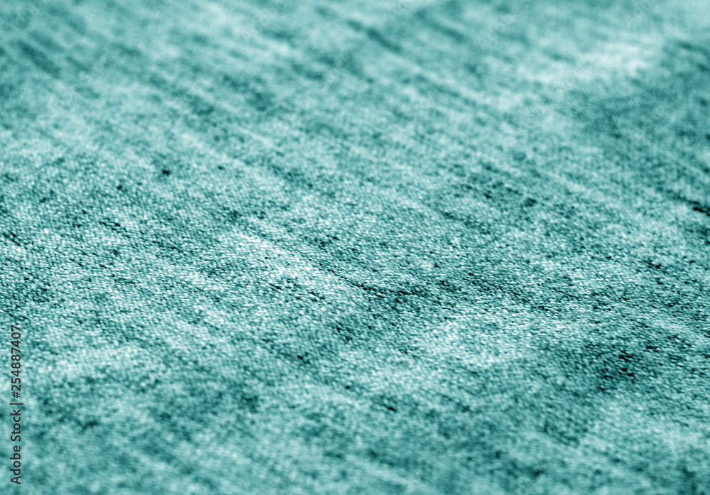 Textile texture with blur effect in cyan tone. Textile texture with blur effect in cyan tone.